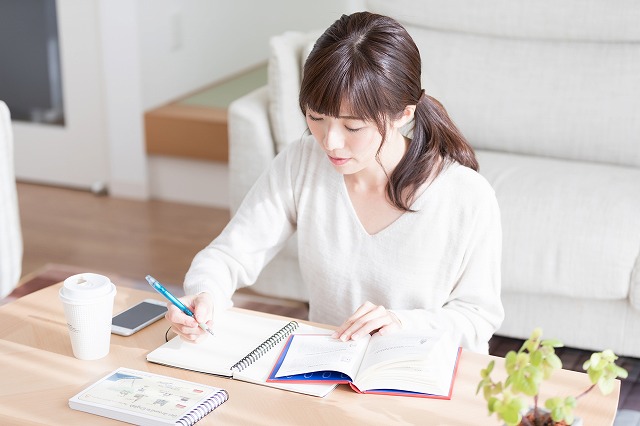 女性が机で勉強している